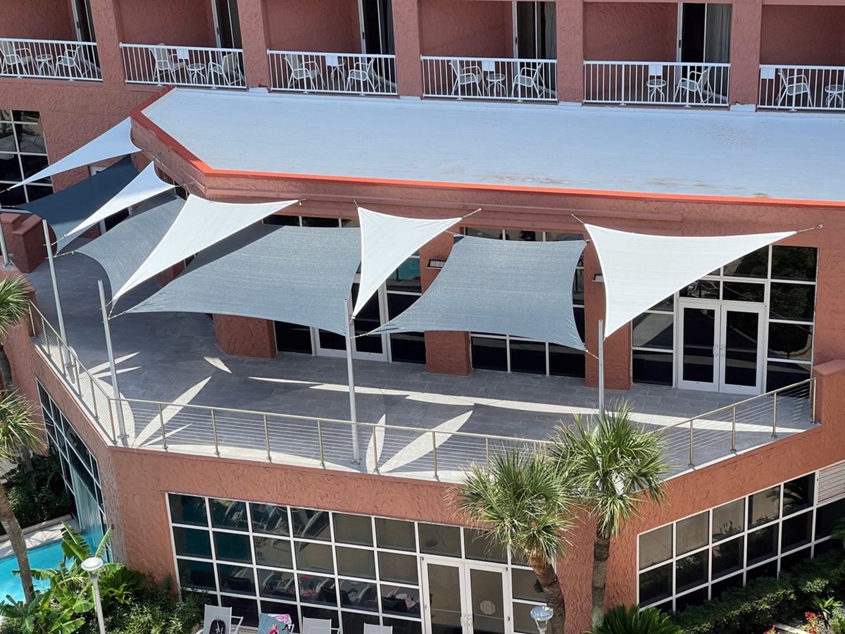 White sails across a hotel courtyard