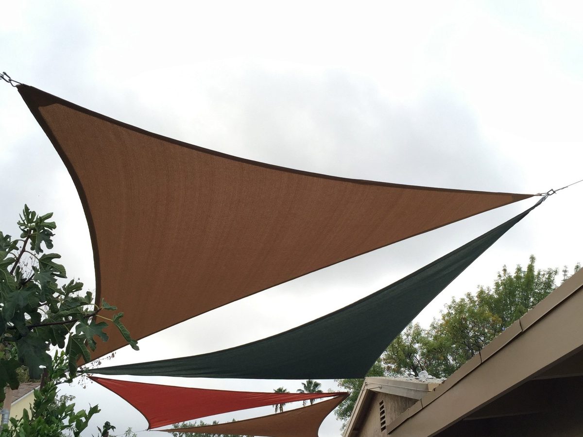 Brown, green and red right triangle sails layered together